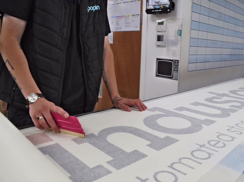 Vehicle wrap specialist working on lorry graphics.