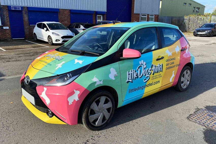 Colourful full vehicle wrap on company car.