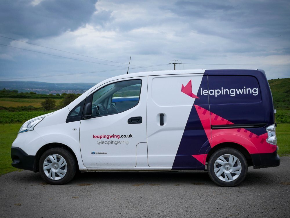 Leaping Wing branded van livery on Nissan enV200.