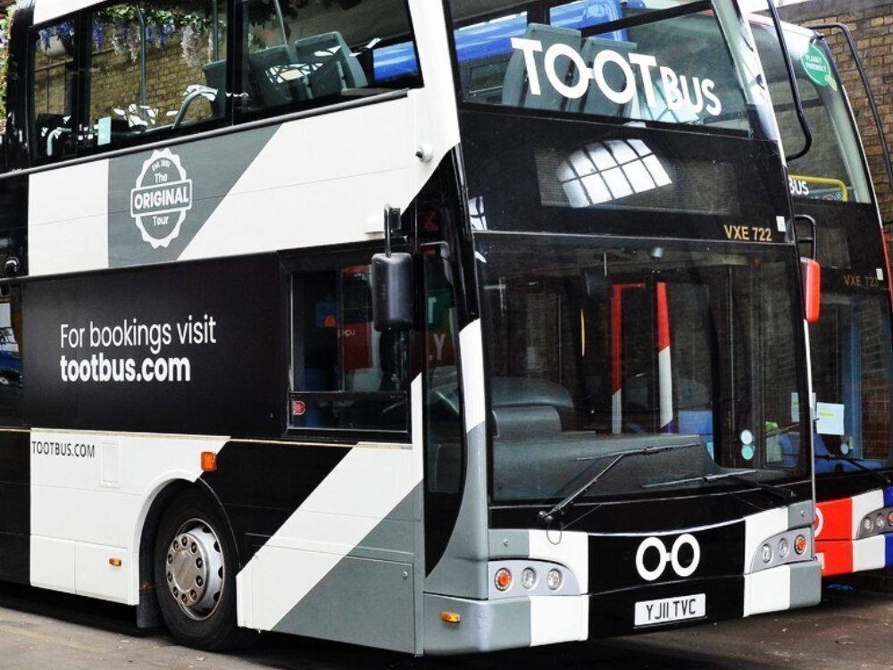 Black and white livery and vehicle window graphics on Tootbus London Bar Bus branded Optare VXE.
