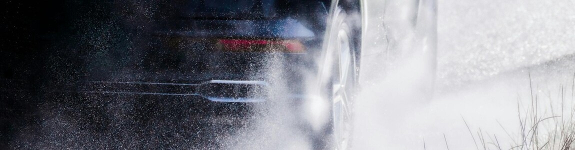 Car driving through a puddle.
