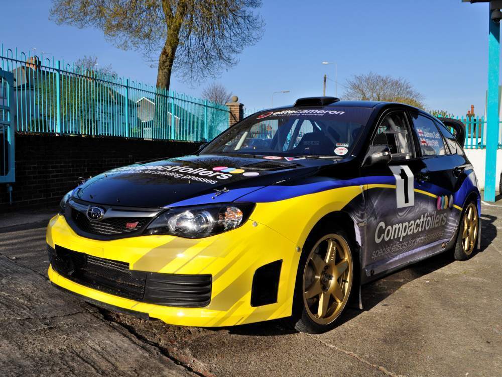 Bold vehicle wrap and graphics on Subaru Impreza B13 company car.