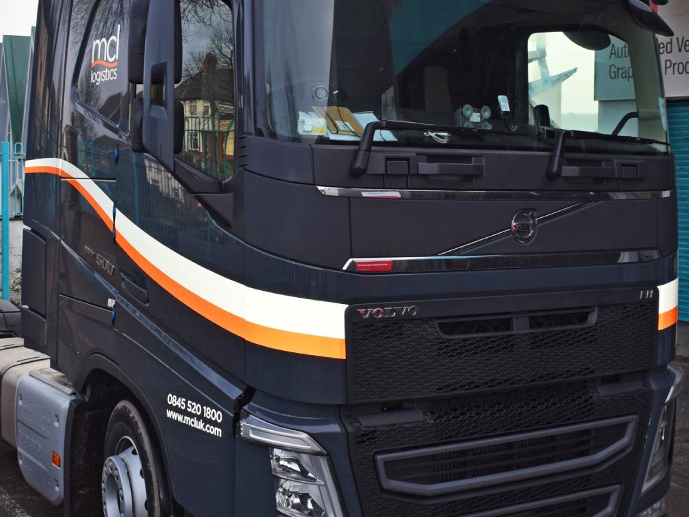 Vehicle graphics on the front cab of a Volvo truck.