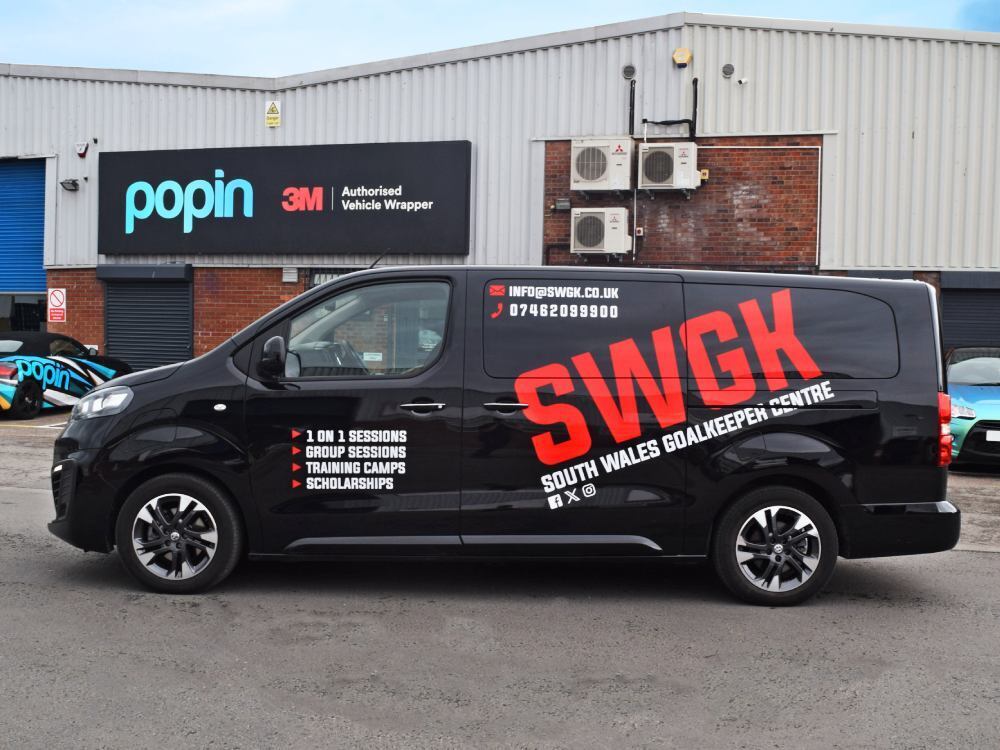 Black Vauxhall Vivaro with red company branded vinyl graphics.