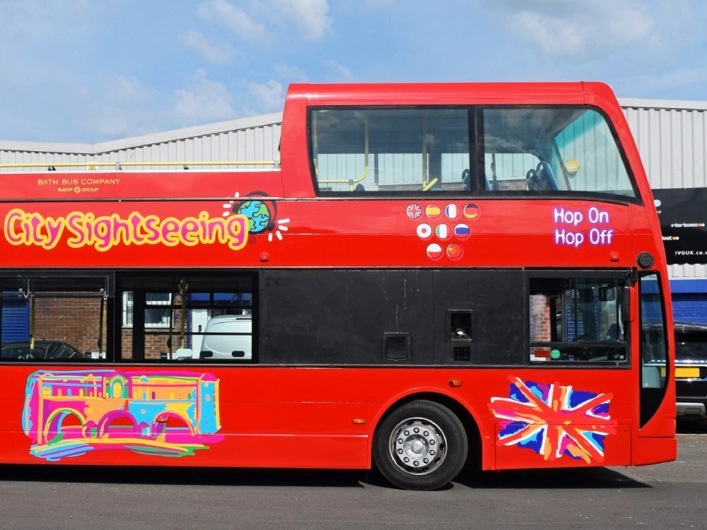Tootbus Bath City Sightseeing branded vinyl graphics on front end of red Optare VLE open top tour bus.