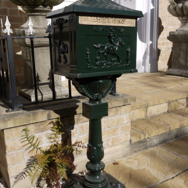 Large green metal postbox.