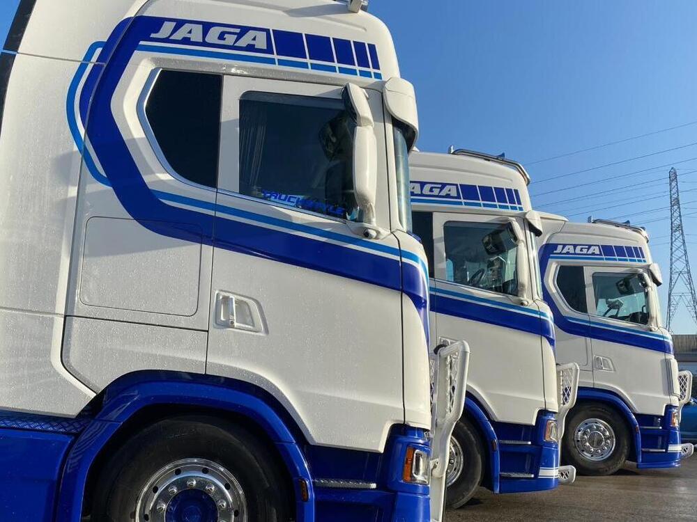 Fleet of Scania trucks with matching blue and white lorry liveries.