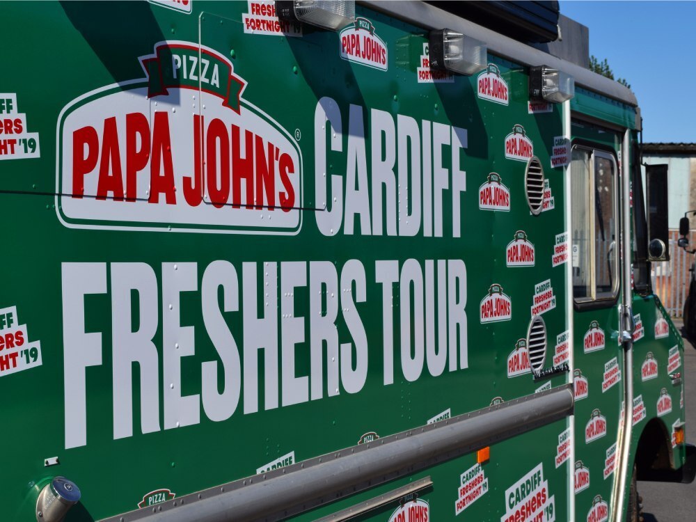 Close up of Papa Johns pizza vehicle graphics on the side of a GMC truck in Cardiff.