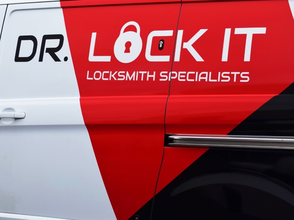 Company vinyl graphics on a white Ford Transit Custom van.