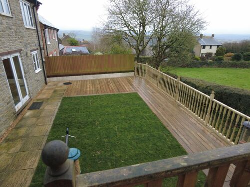 A wooden decked area looking out over the countryside. Landscapers in Dorchester