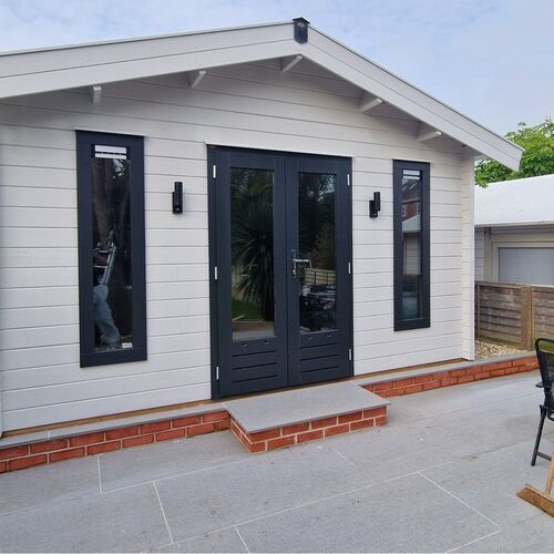 a beautiful family gamers room log cabin garden building painted in china clay white