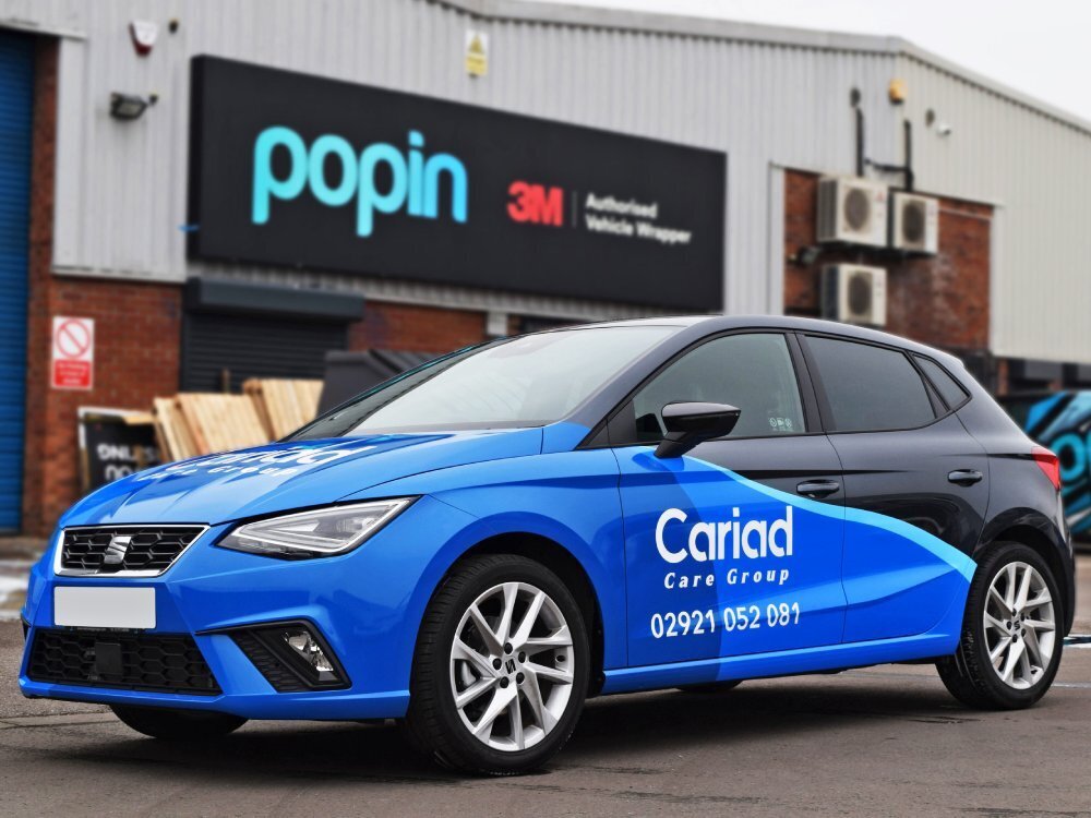 SEAT company car with branded vehicle wrap.