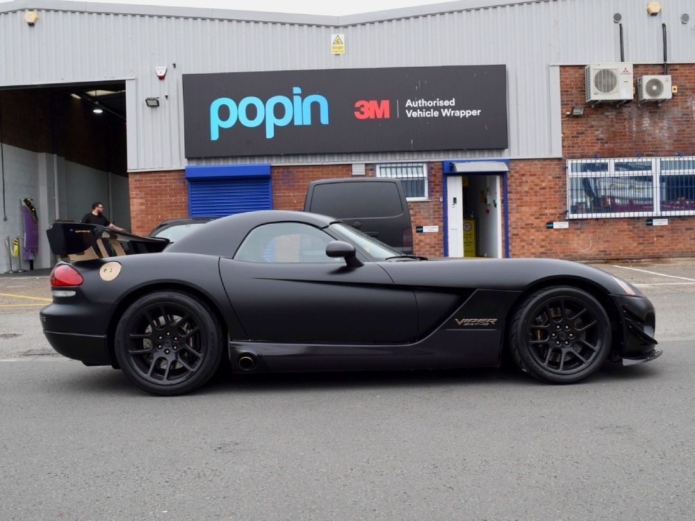Side profile of Dodge Viper SRT10 sports car with matte black livery