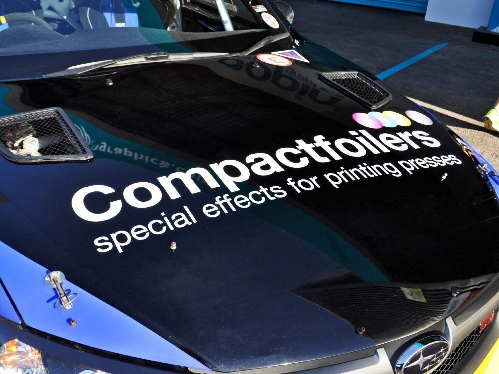 Business branding vinyl graphics on bonnet of Subaru Impreza B13 company car.