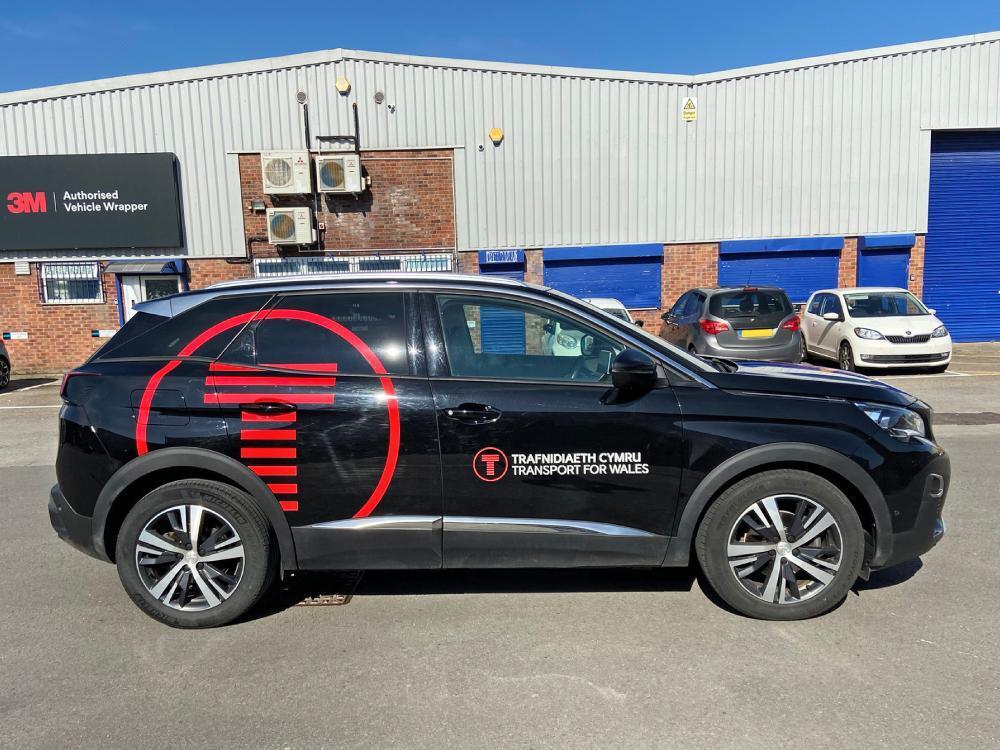 Black company Peugeot 3008 car with vinyl graphics.