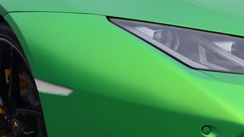 Green satin vehicle wrap on Lamborghini Huracan sports car.