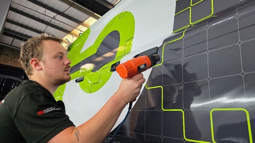 Vehicle wrap and graphics being installed on a van