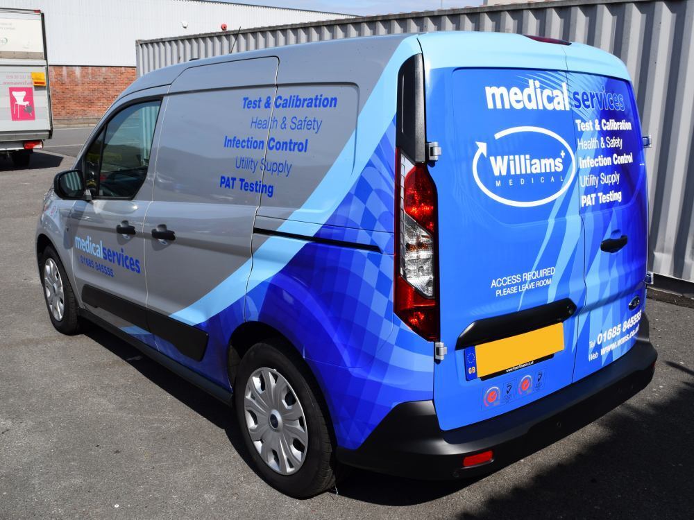 Silver and blue vehicle wrap on company Ford Transit Connect van.