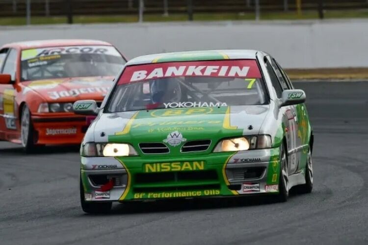 Nissan Primera with motorsport wrap and graphics during a race.