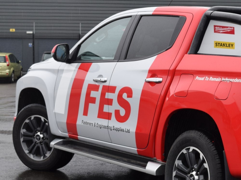 Red and grey vehicle wrap and graphics on Mitsubishi L200.