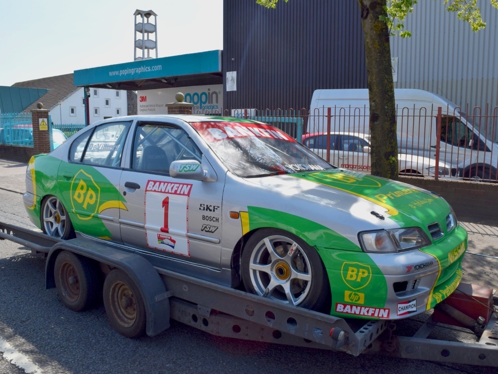 Nissan Primera race car being transported after motorsport livery and graphics installation