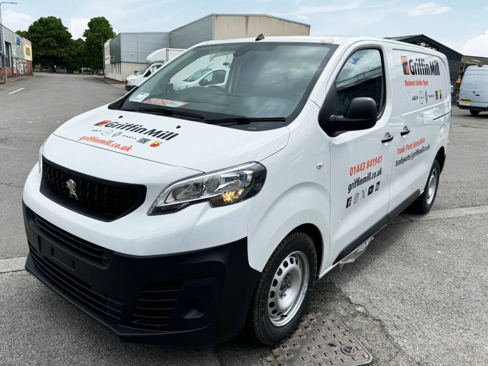Van vinyl graphics on white company Peugeot Expert.