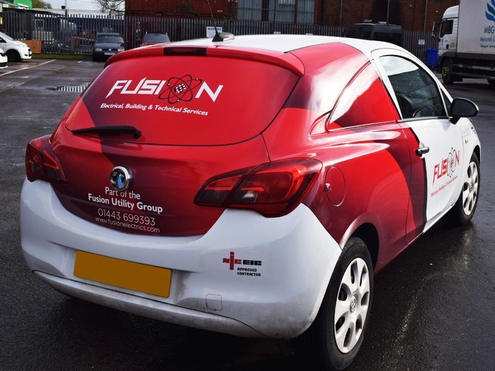 Red and white vehicle wrap and branded vinyl graphics on Vauxhall Corsa company car.