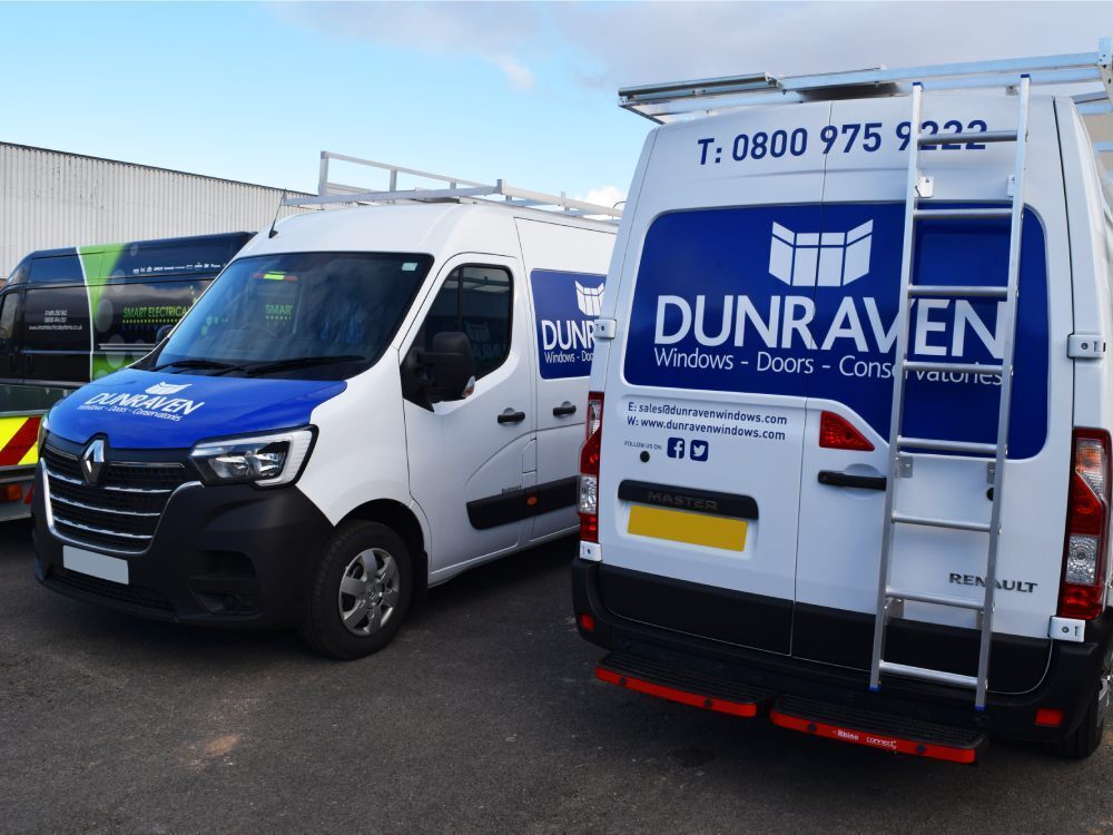 Blue company branded vinyl graphics on fleet of Renault Master vans.