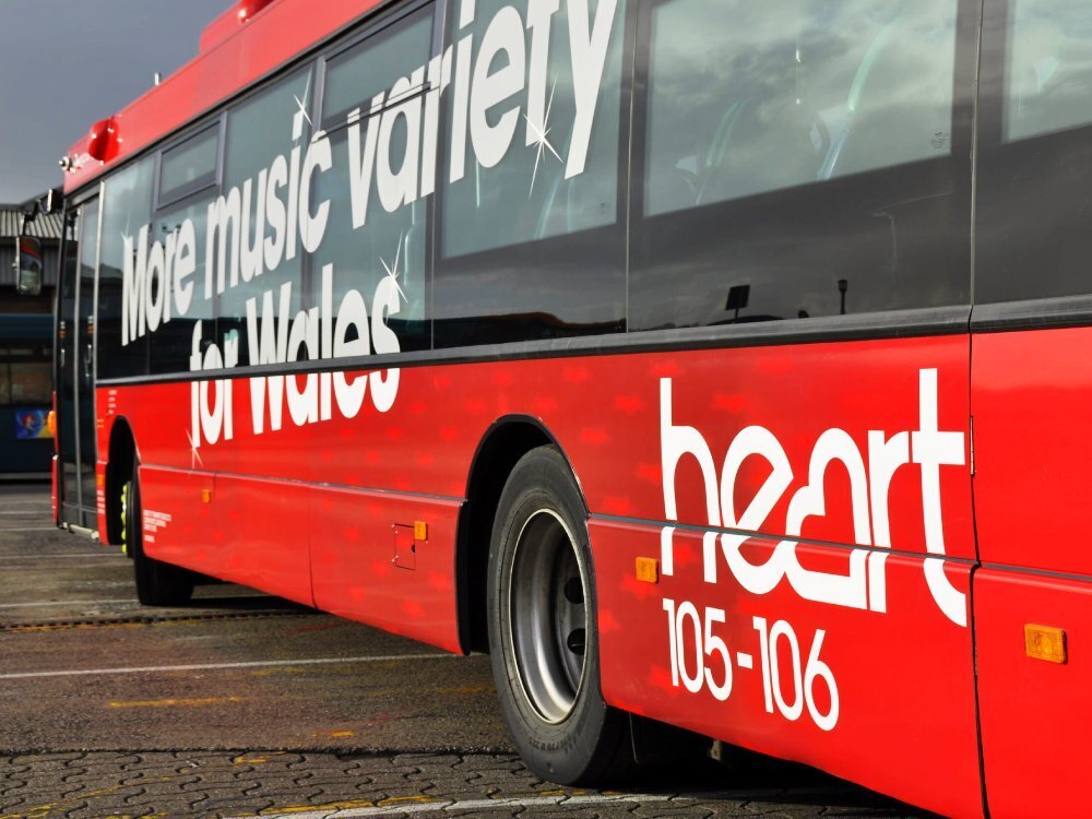 Scania Omnilink Cardiff Bus with red vehicle livery and Heart FM advertising vinyl graphics.
