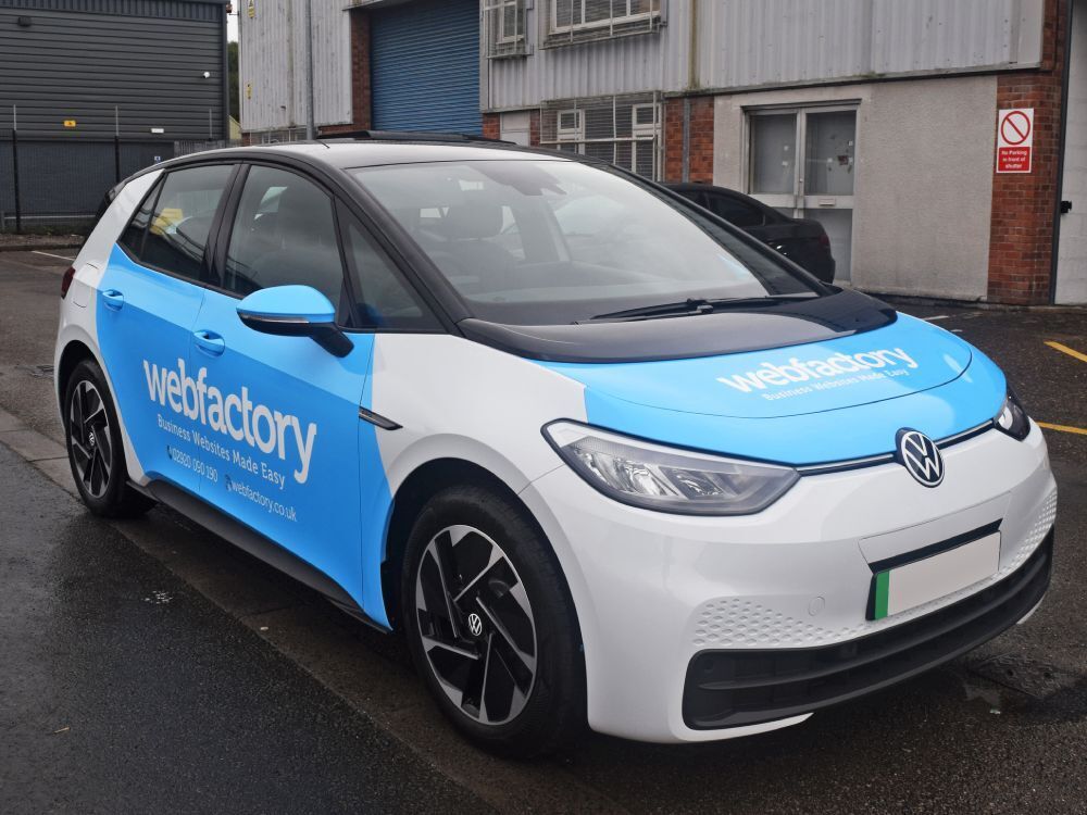 Volkswagen ID3 company car with branded partial vehicle wrap and vinyl graphics.
