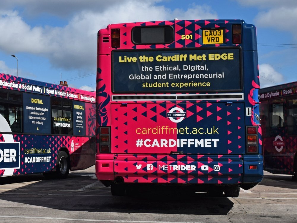 Rear of Dennis Dart bus with branded vehicle wrap and advertising vinyl graphics.