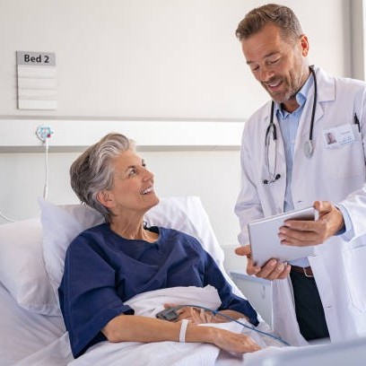 Woman in private hospital speaking to a male doctor