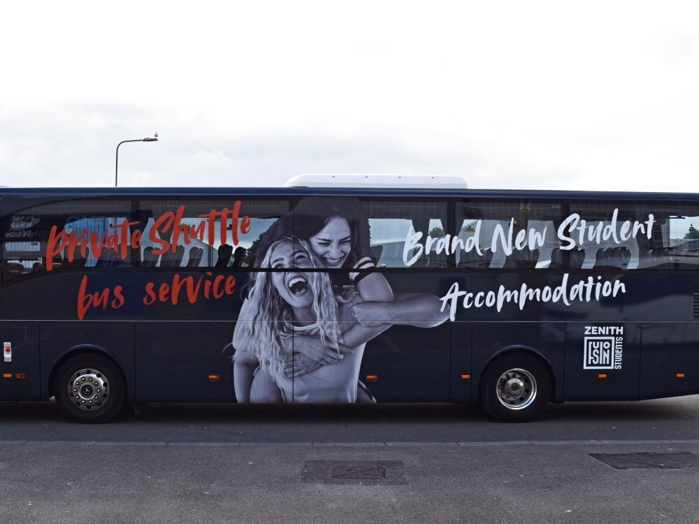 Promotional vehicle wrap and branded graphics for Zenith Student Accommodation installed on side of Mercedes Tourismo coach.