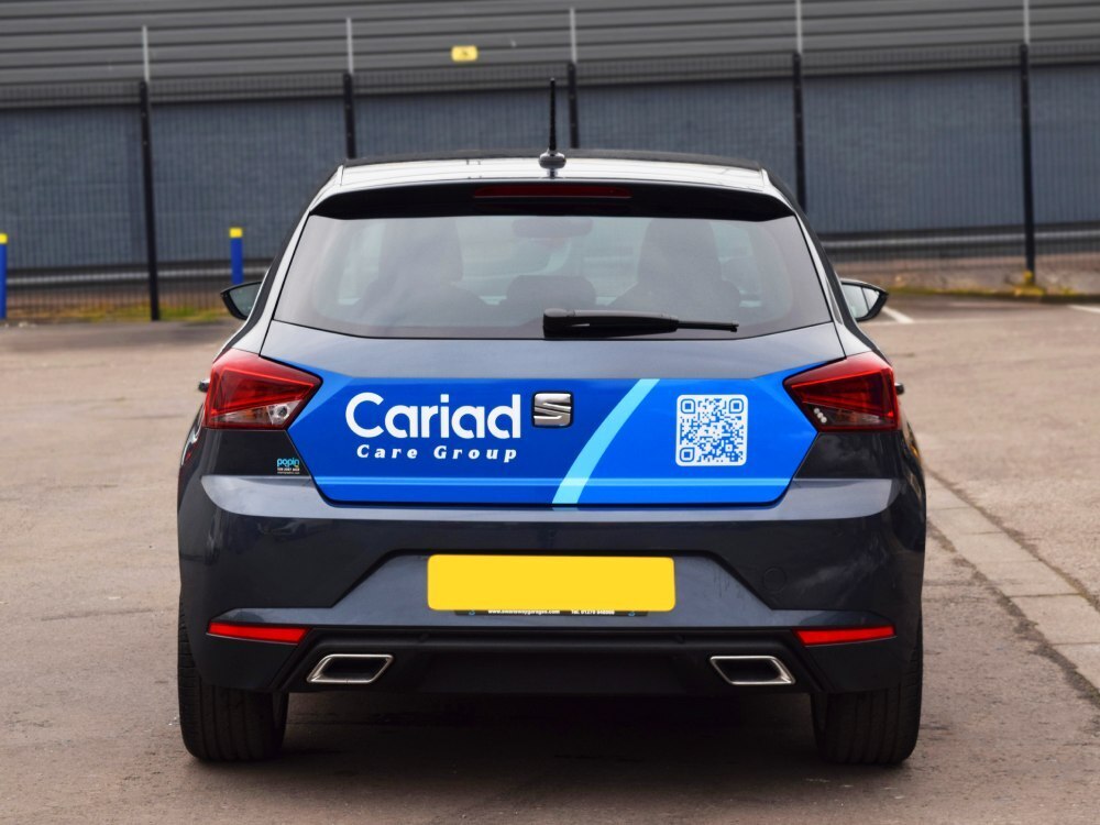 Rear of SEAT Ibiza company car with vehicle wrap and branded vinyl graphics.