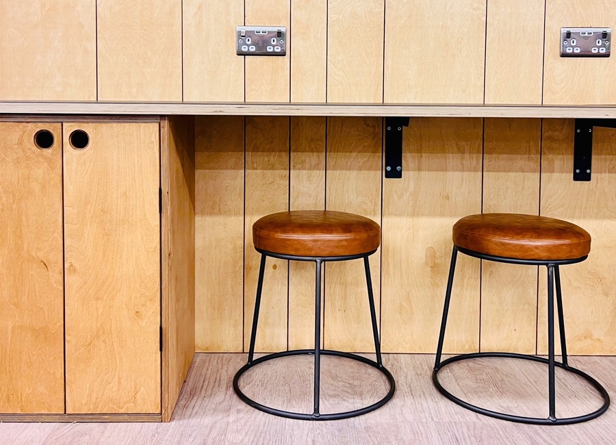 Breakout space with bench seating and a storage cupboard made from Birch ply