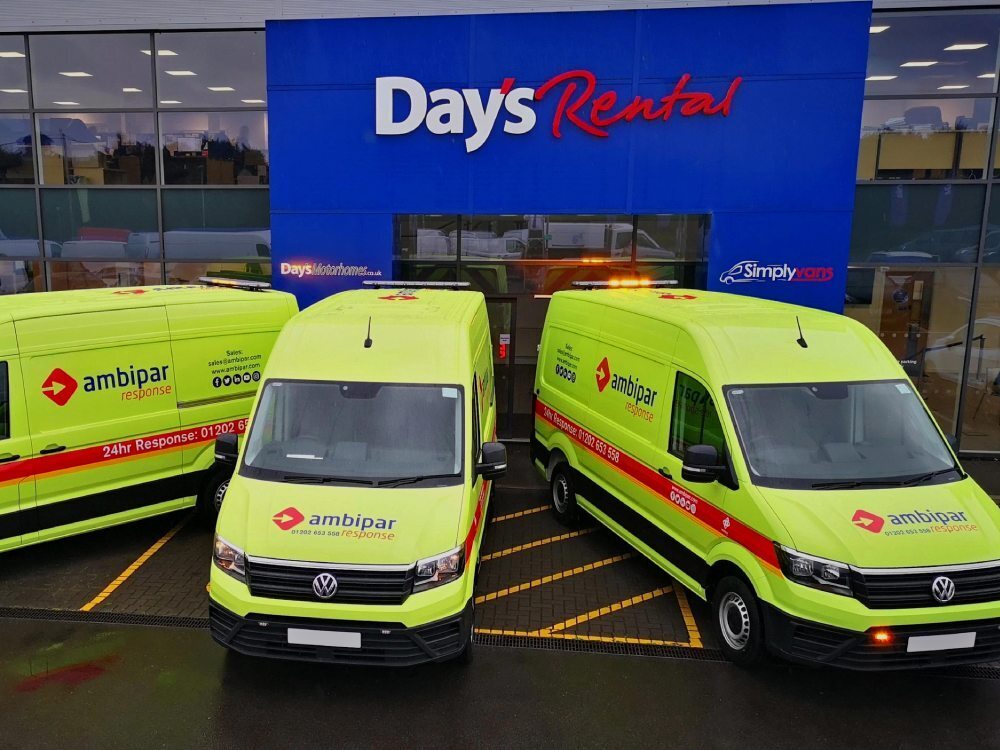 Fleet of company vans with matching bright yellow branded vinyl liveries.
