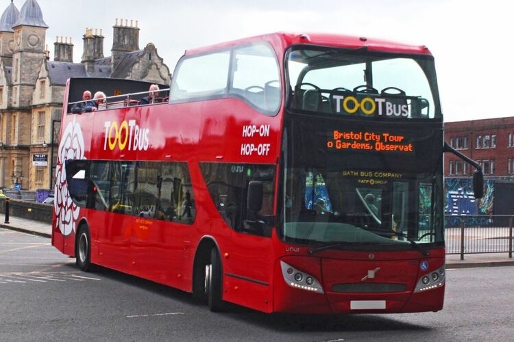 UNVI Urbis Bristol open top tour bus with red livery and Tootbus branded vehicle graphics.