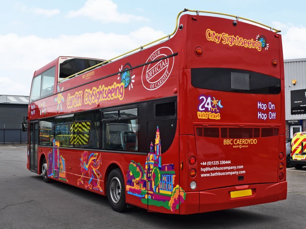 Rear of red Optare VLE open top tour bus with Cardiff City Sightseeing vinyl graphics.