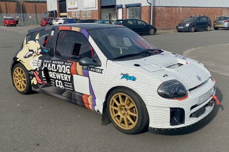 Renault Clio V6 rally car with motorsport wrap and graphics.