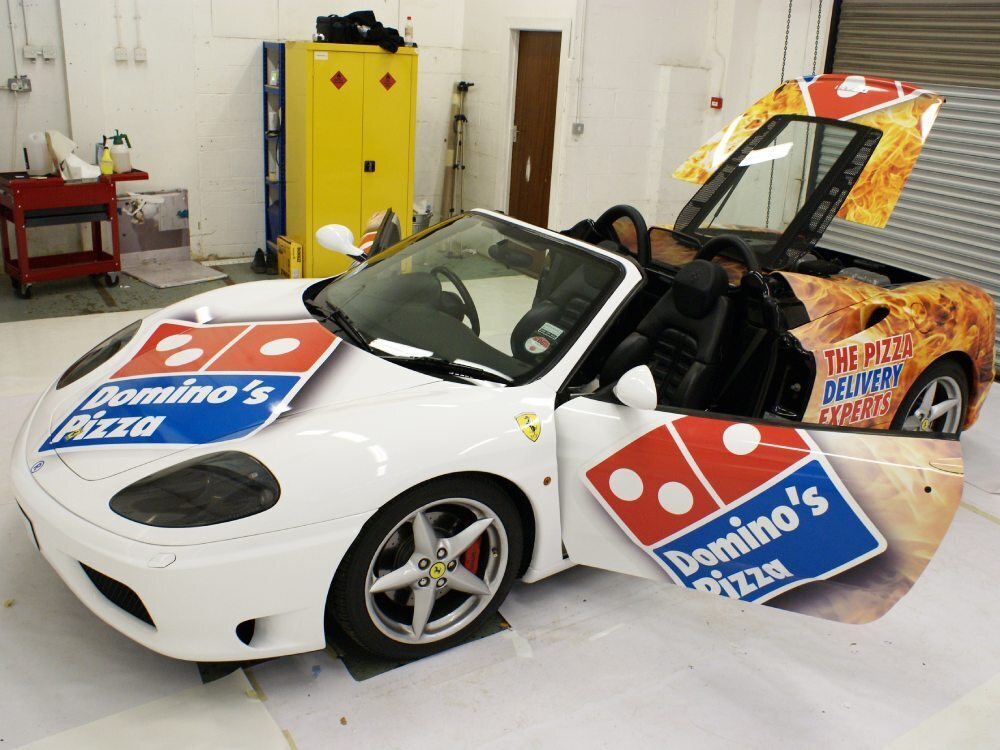 Partial Domino's Pizza car wrap and vinyl graphics on a white Ferrari 360 Spider.