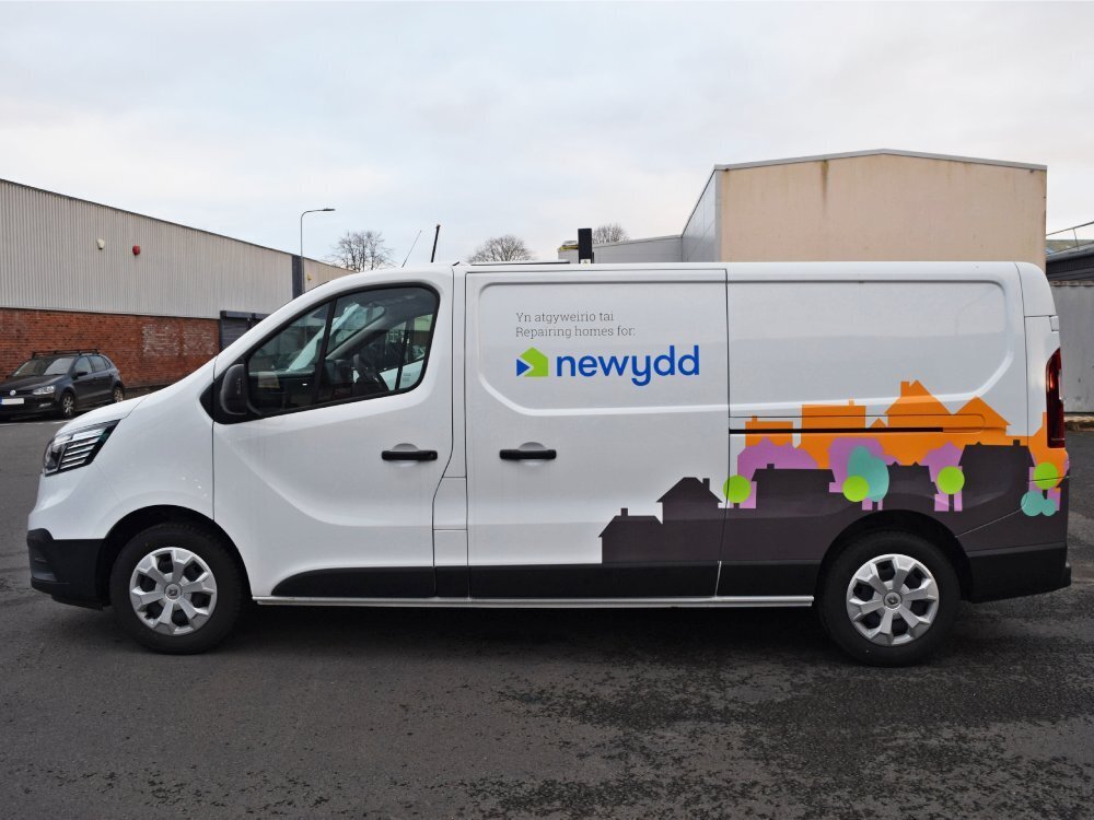 Partial van wrap and graphics on company Renault Trafic vehicle.