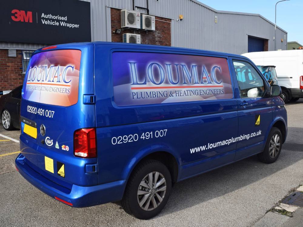 Blue Volkswagen Transporter with infilled panel graphics advertising business outside Popin in Cardiff.