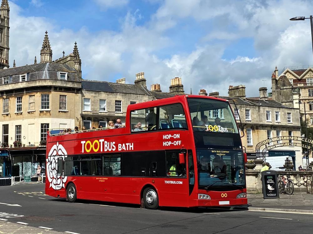 Tootbus Bath branded commercial graphics on red Optare VLE open top bus.