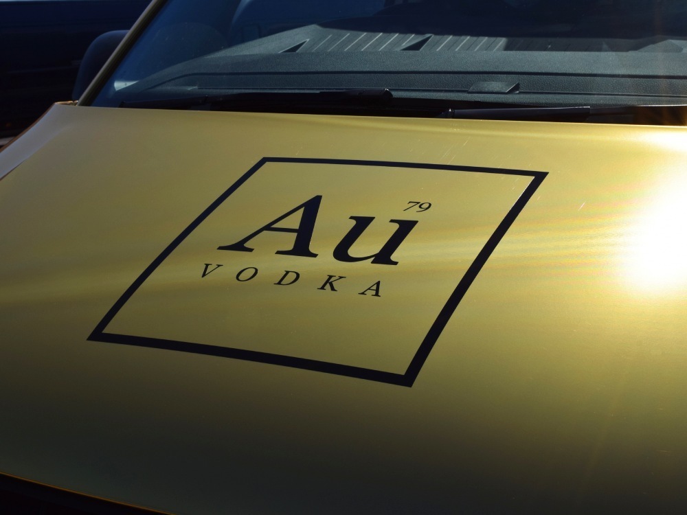 Au Vodka vinyl graphic on gold Volkswagen Transporter van.