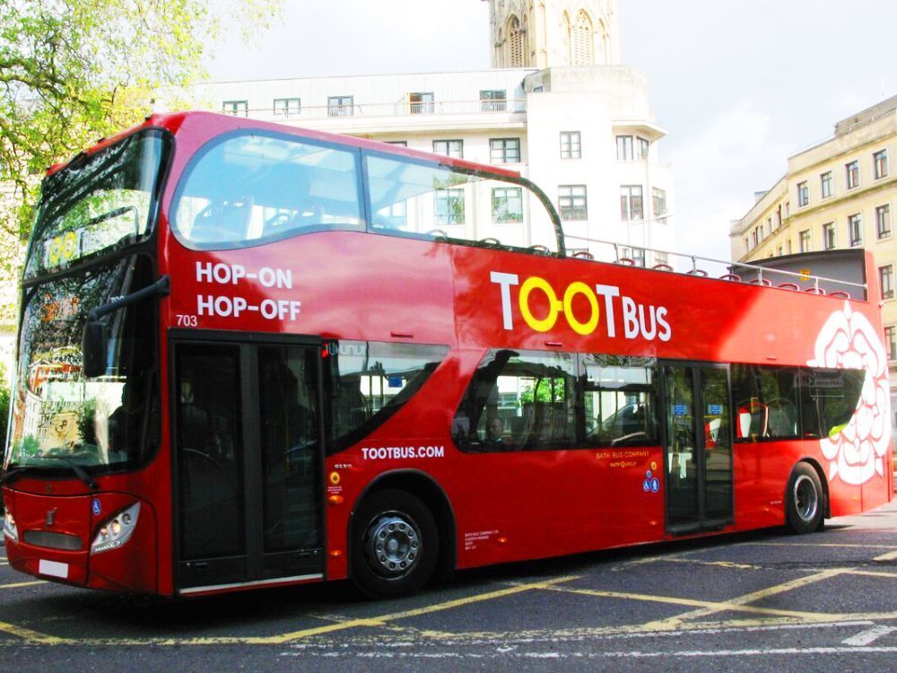 Red UNVI Urbis open top tour bus with Tootbus Bristol branded vinyl graphics.