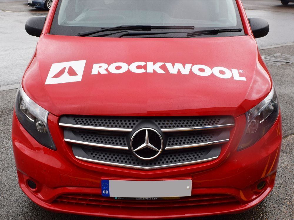 Rockwool vinyl graphics installed on front of red company Mercedes Vito van.