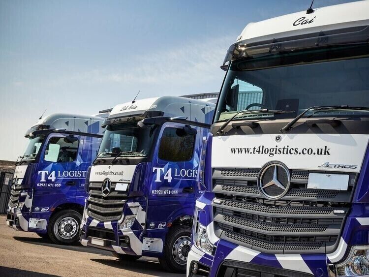 Fleet of lorries with matching branded vehicle wraps.