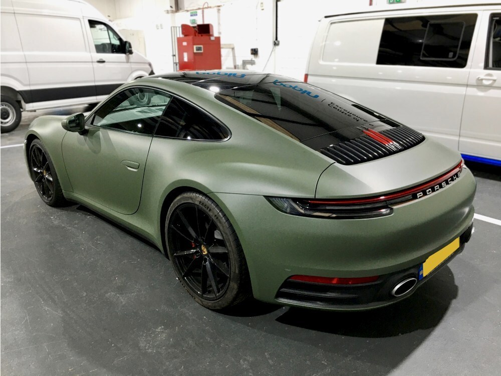 Khaki green motorsport livery on a Porsche 911 sports car