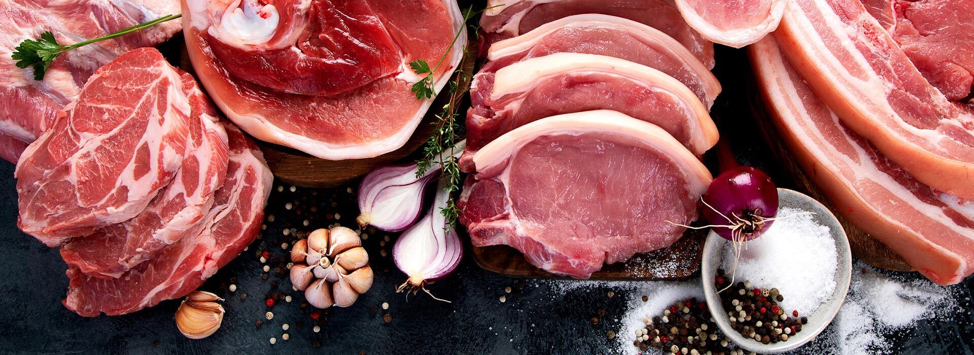 Raw pork cuts including loin chops, shoulder and belly