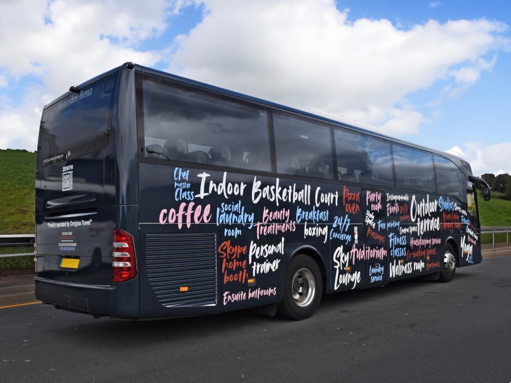 Funky font text vinyl graphics on black Mercedes Tourismo coach.